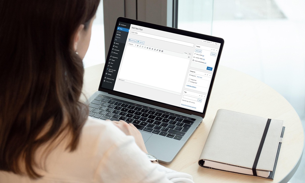 Professional reviewing a company blog and buyer enquiries on a laptop