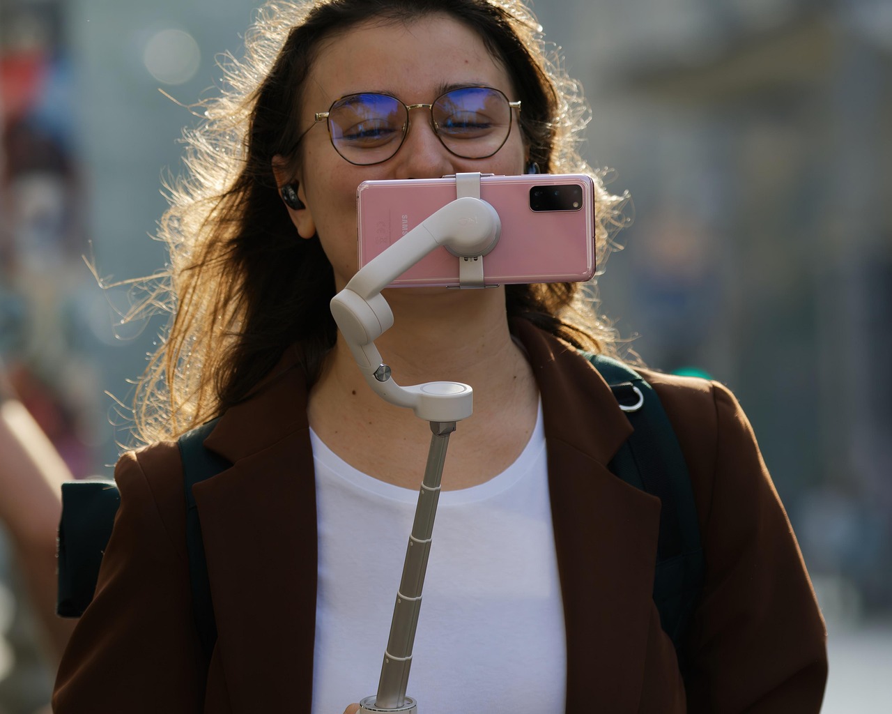 Content creator filming a video with a smartphone gimbal