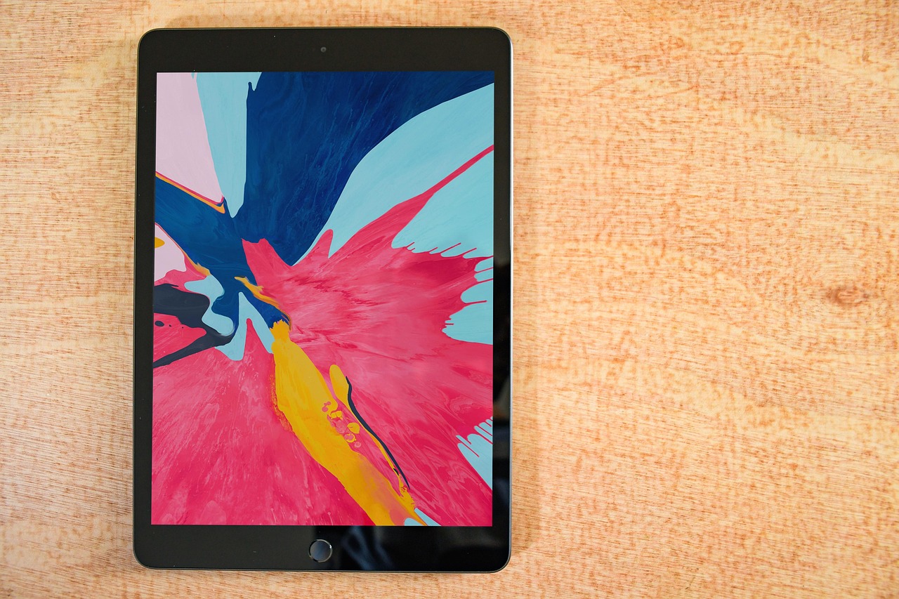Tablet displaying a colourful digital illustration on a desk