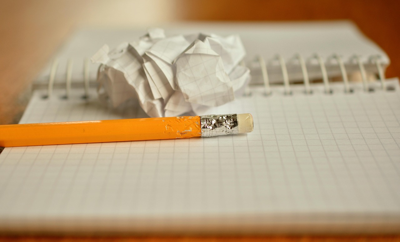 Pencil resting on an open notebook ready for editing notes